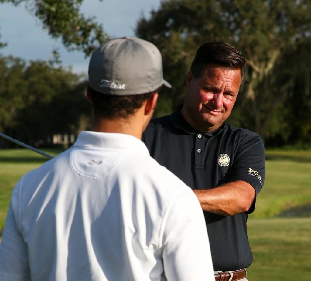 Image of Brad Myers teaching a student on a golf course